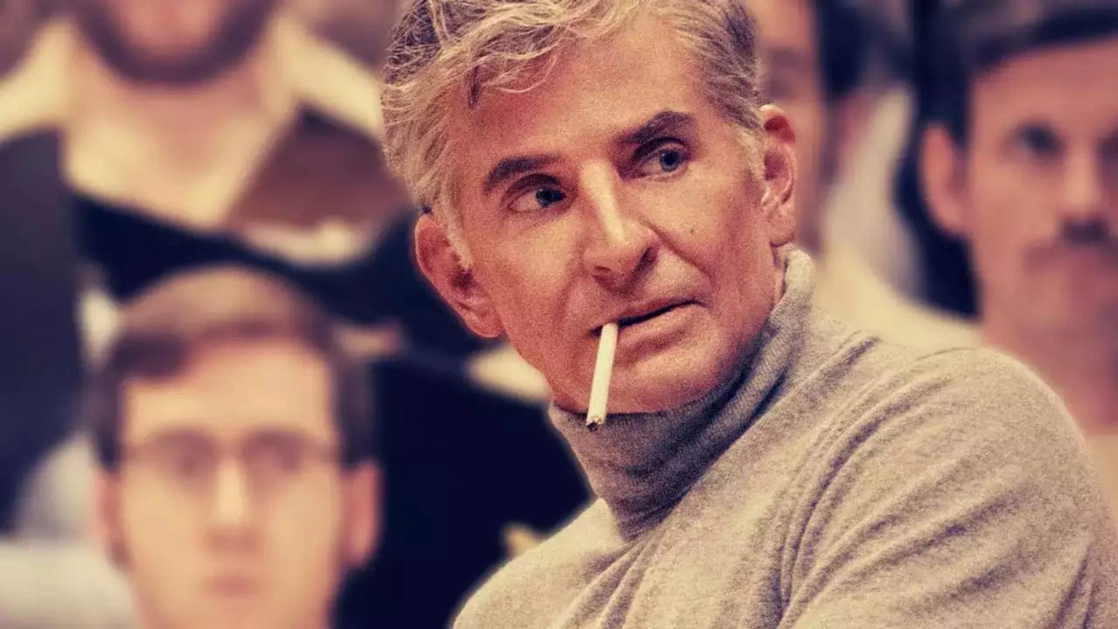 Bradley Cooper as Leonard Bernstein in Maestro smoking a cigarette
