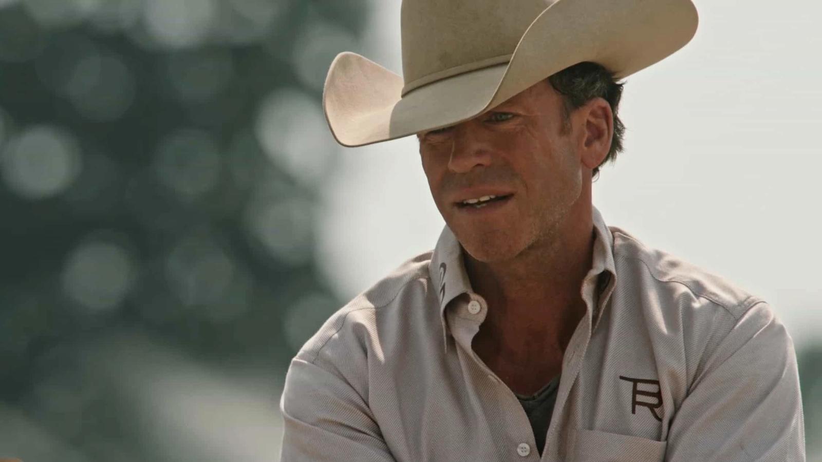 Taylor Sheridan as Travis in Yellowstone, wearing a cowboy hat