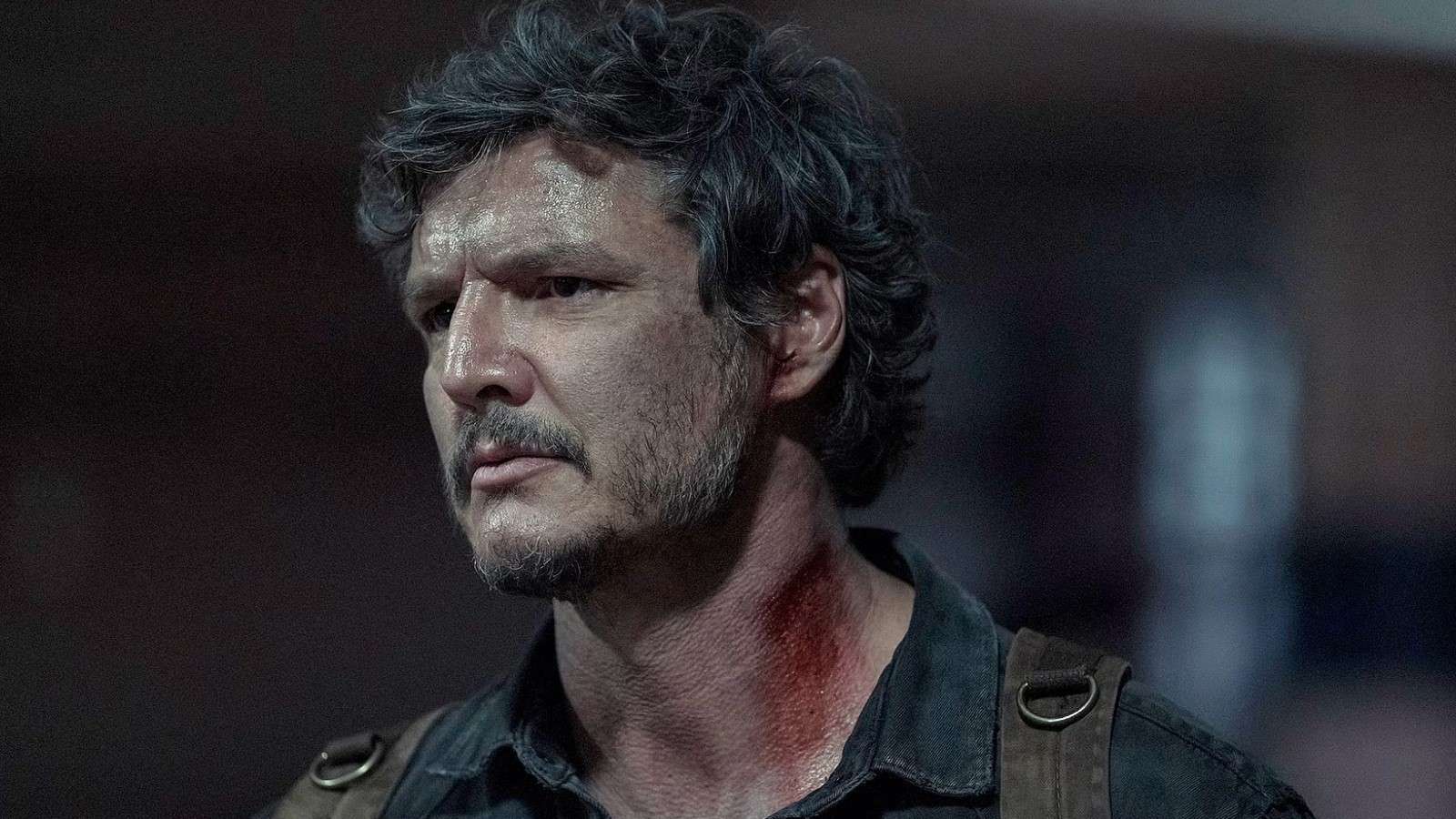 Pedro Pascal as Joel in The Last of Us, standing in a dark room