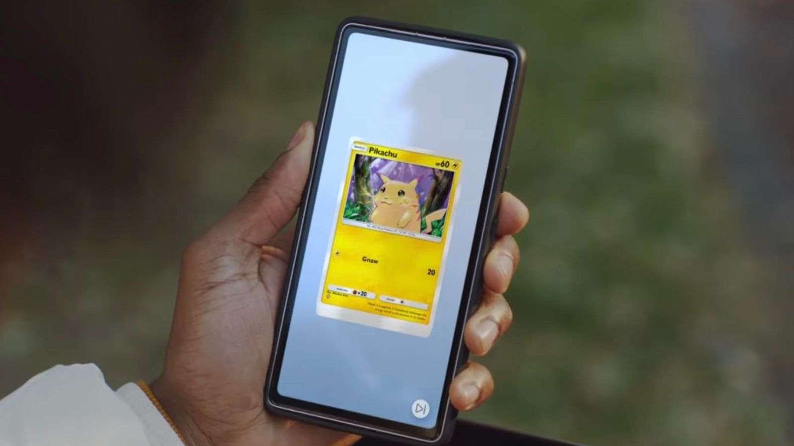 Hand holding Pokemon TCG Pocket screen.