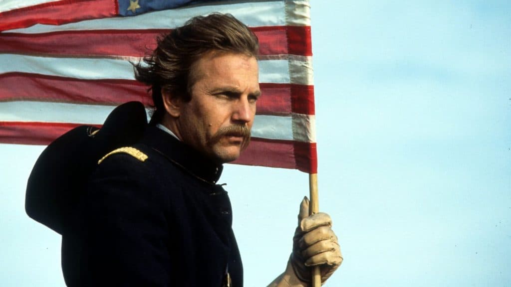Kevin Costner in Dances With Wolves, holding an American Flag