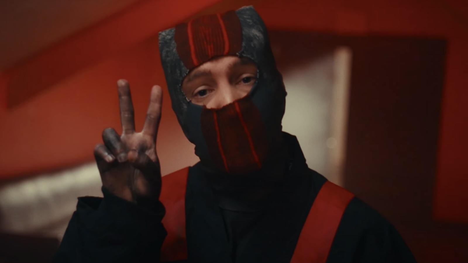 Twenty One Pilots hold up a peace sign in 'Overcompensate' video