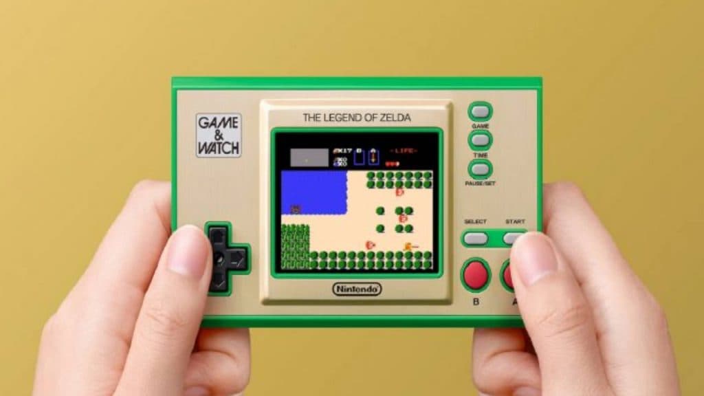 A pair of hands hold the Legend of Zelda Game and Watch