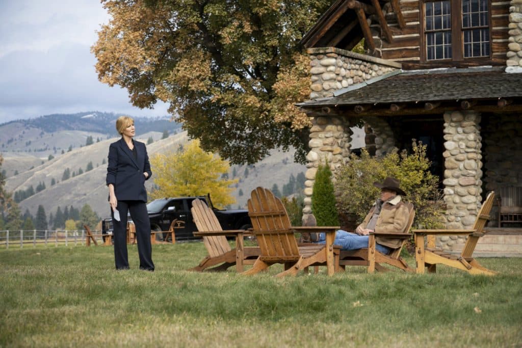 Beth and John Dutton sit outside the Dutton family ranch house in Yellowstone