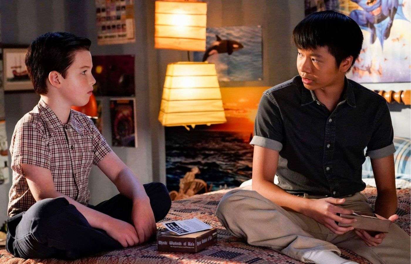 Sheldon and Tam sitting on Sheldon's bed in Young Sheldon.