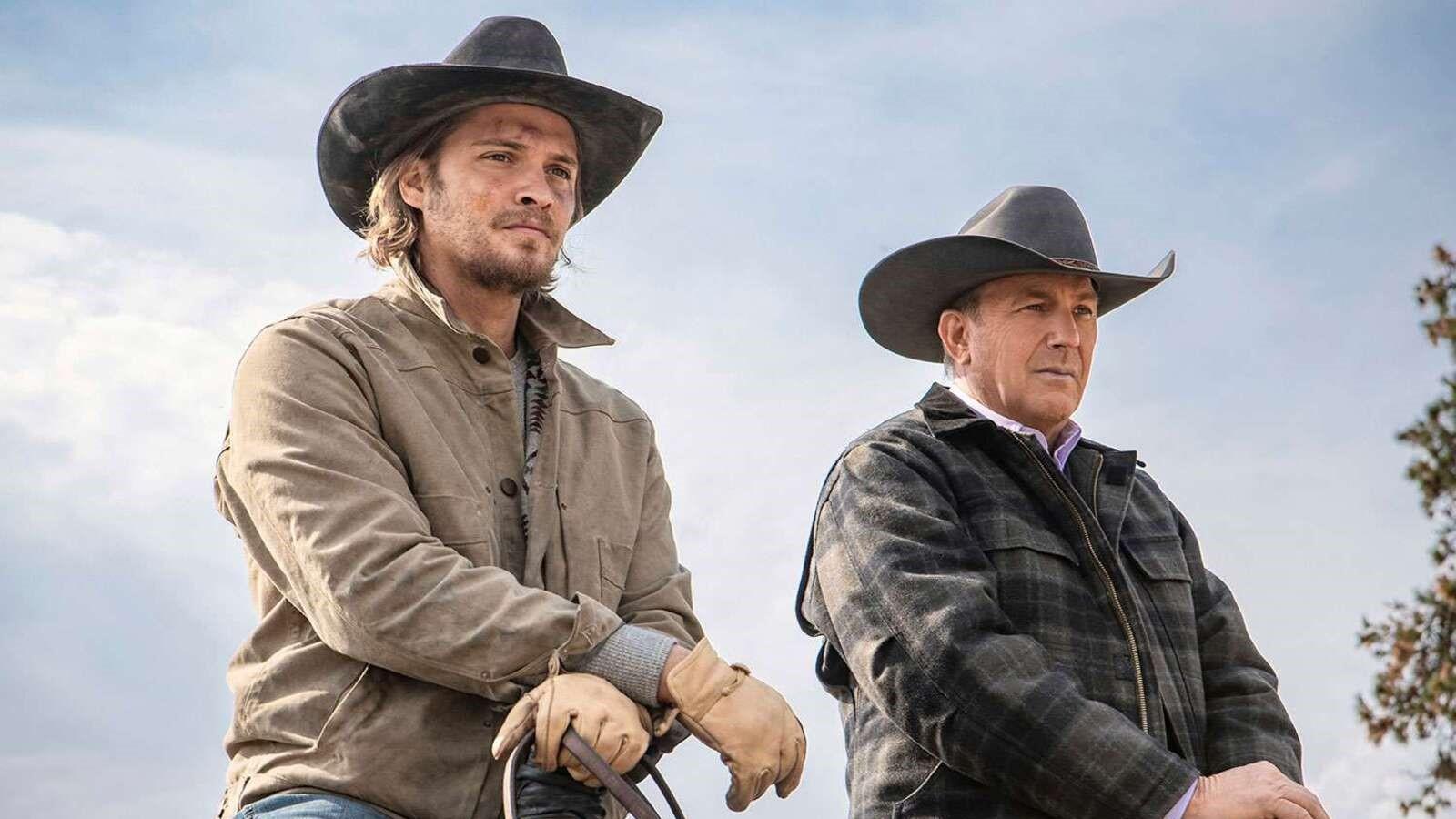 Luke Grimes and Kevin Costner as Kayce and John Dutton in Yellowstone, sitting on horses and looking into the distance