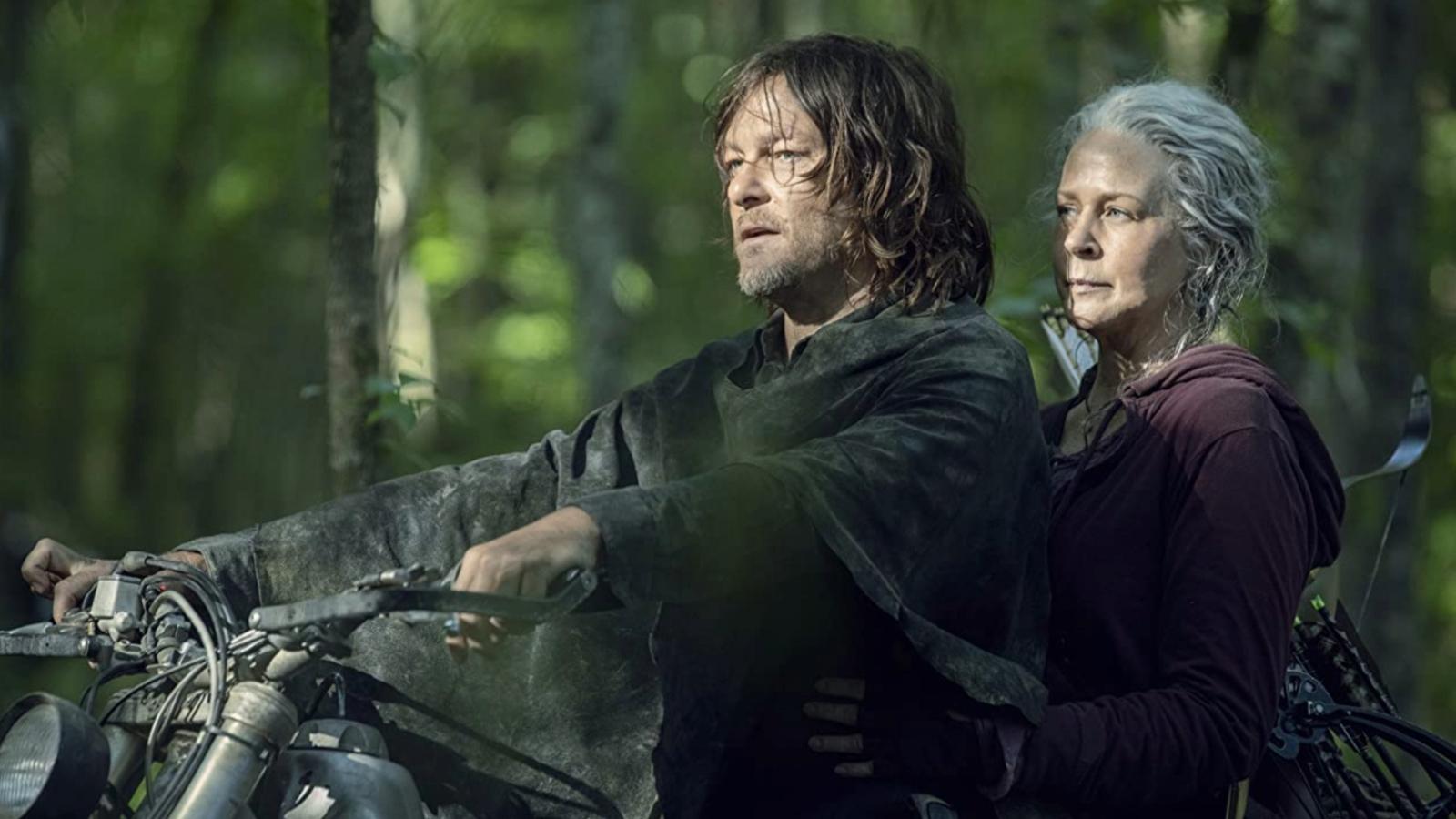 Norman Reedus and Melissa McBride as Daryl and Carol in The Walking Dead, sitting on a motorcycle