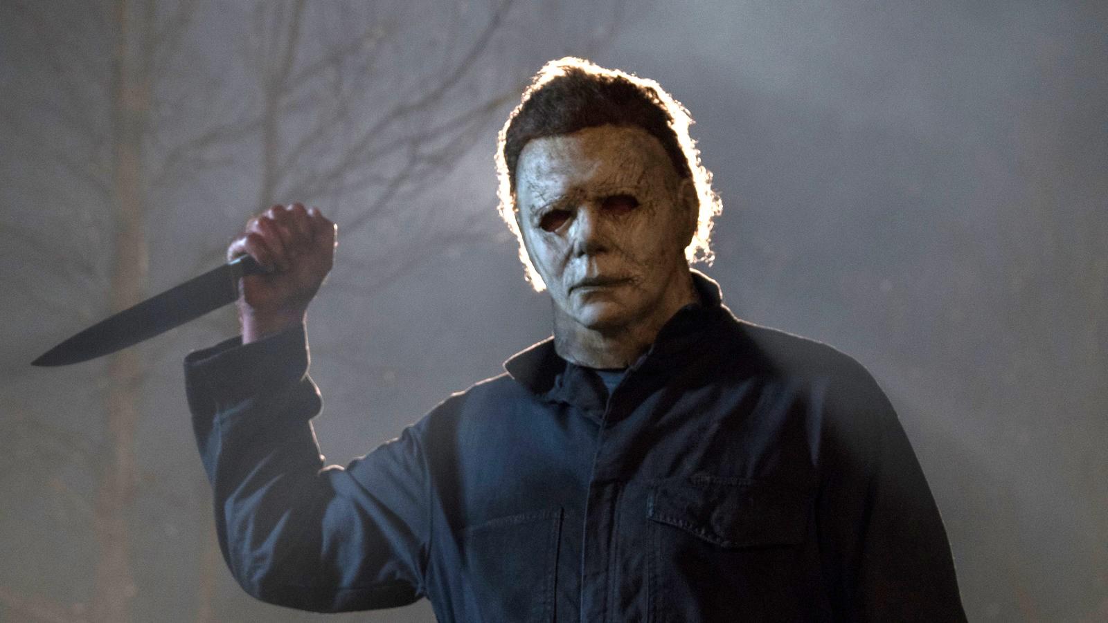 Michael Myers in Halloween Ends, standing in the dark and holding a knife