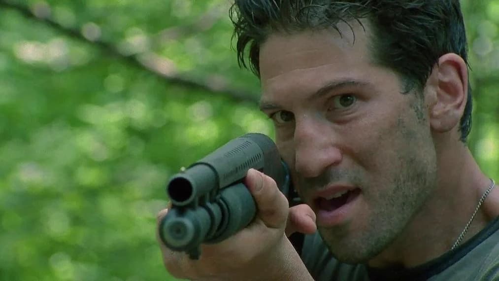 Jon Bernthal as Shane in The Walking Dead, holding up a gun
