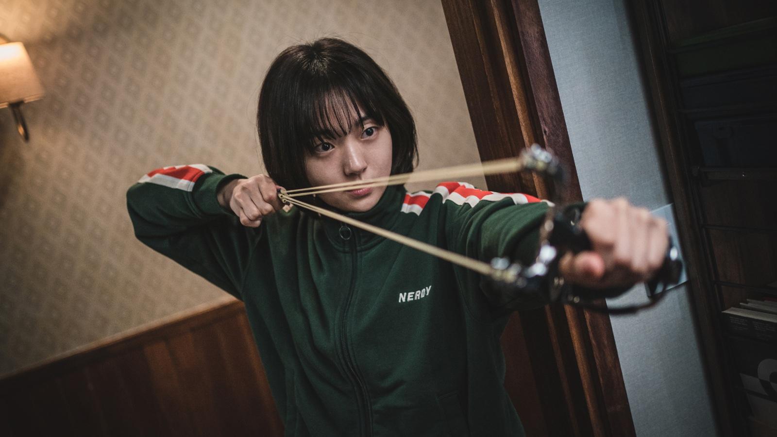 Kim Hye-joon in A Shop For Killers with a slingshot.