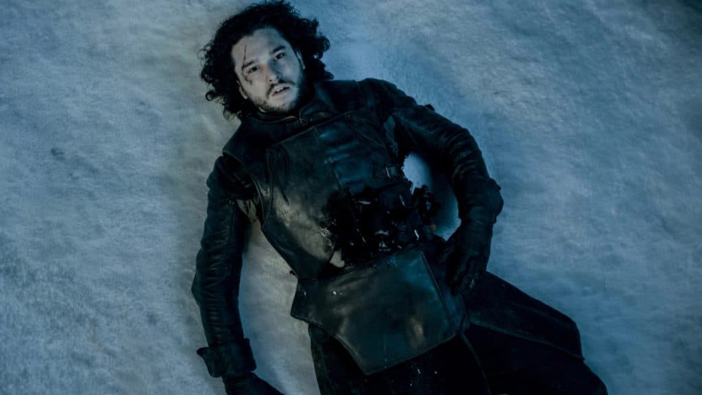 Kit Harington as Jon Snow in Game of the Thrones, lying on the ground, bleeding