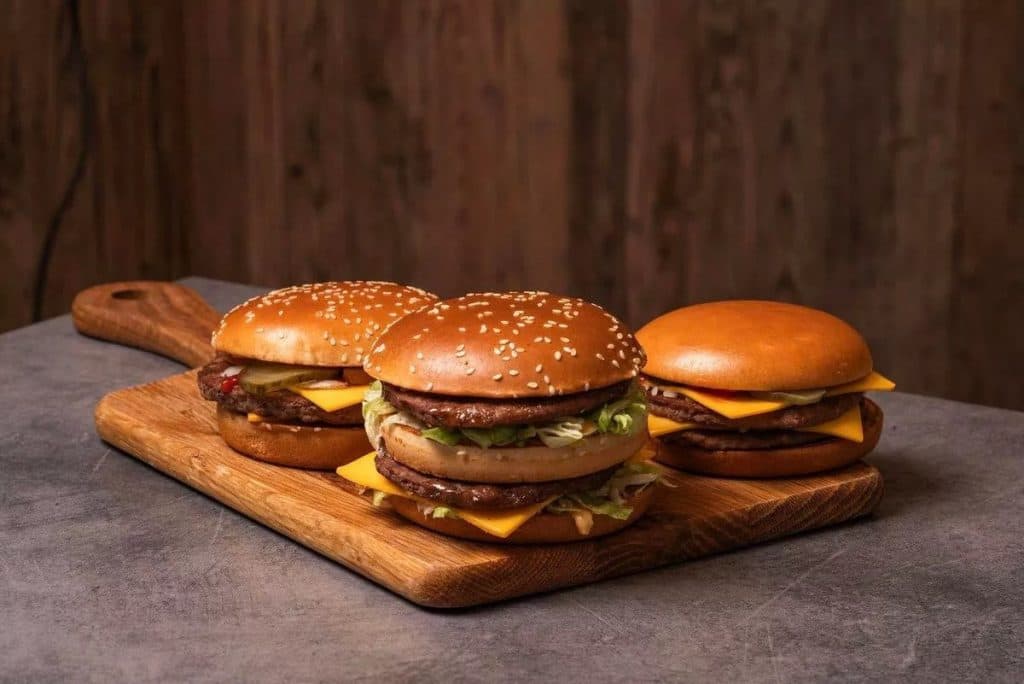Three new recipe McDonald's burgers on a wooden chopping board