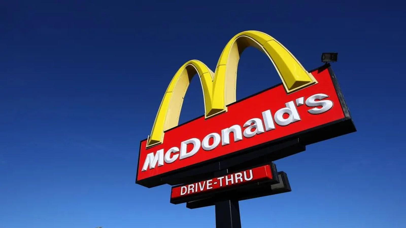 A low-angle photo of the Mcdonald's sign against a blue sky background.
