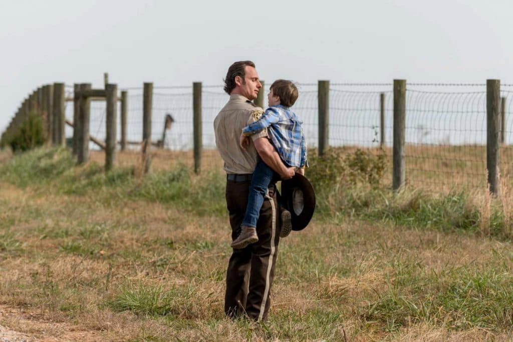 Rick holds a young Carl in his arms in The Walking Dead