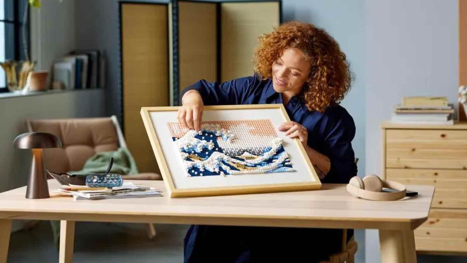 An adult with their LEGO Art Hokusai – The Great Wave set