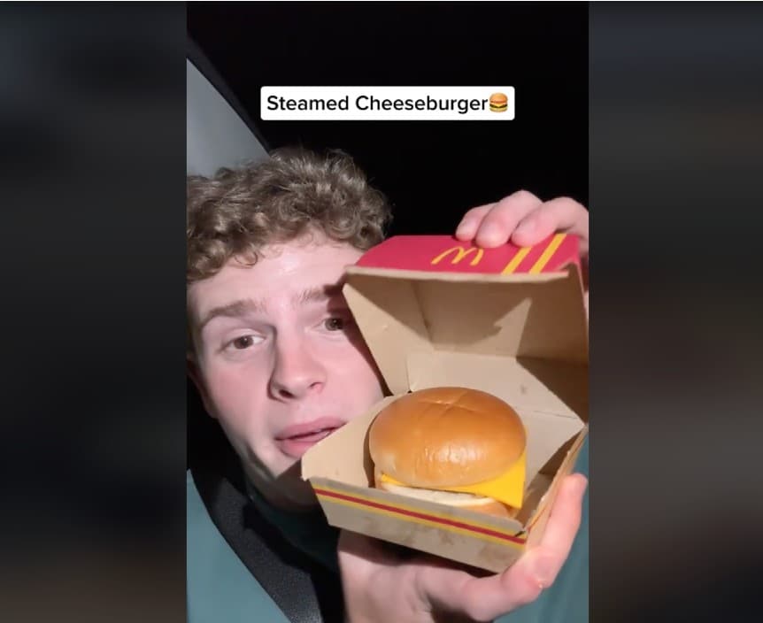 photo of a TikToker holding up a burger