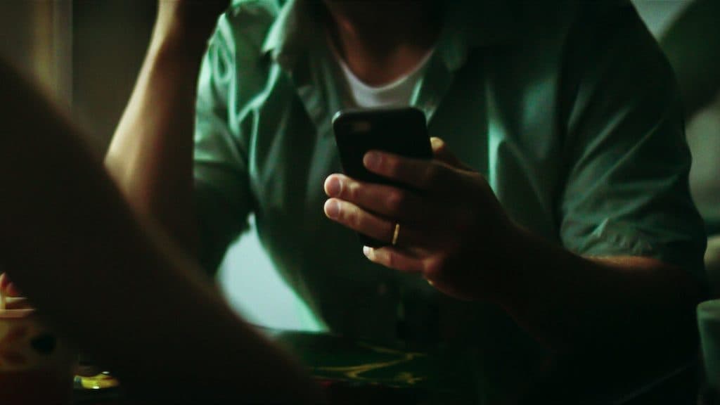 Still of person on their phone