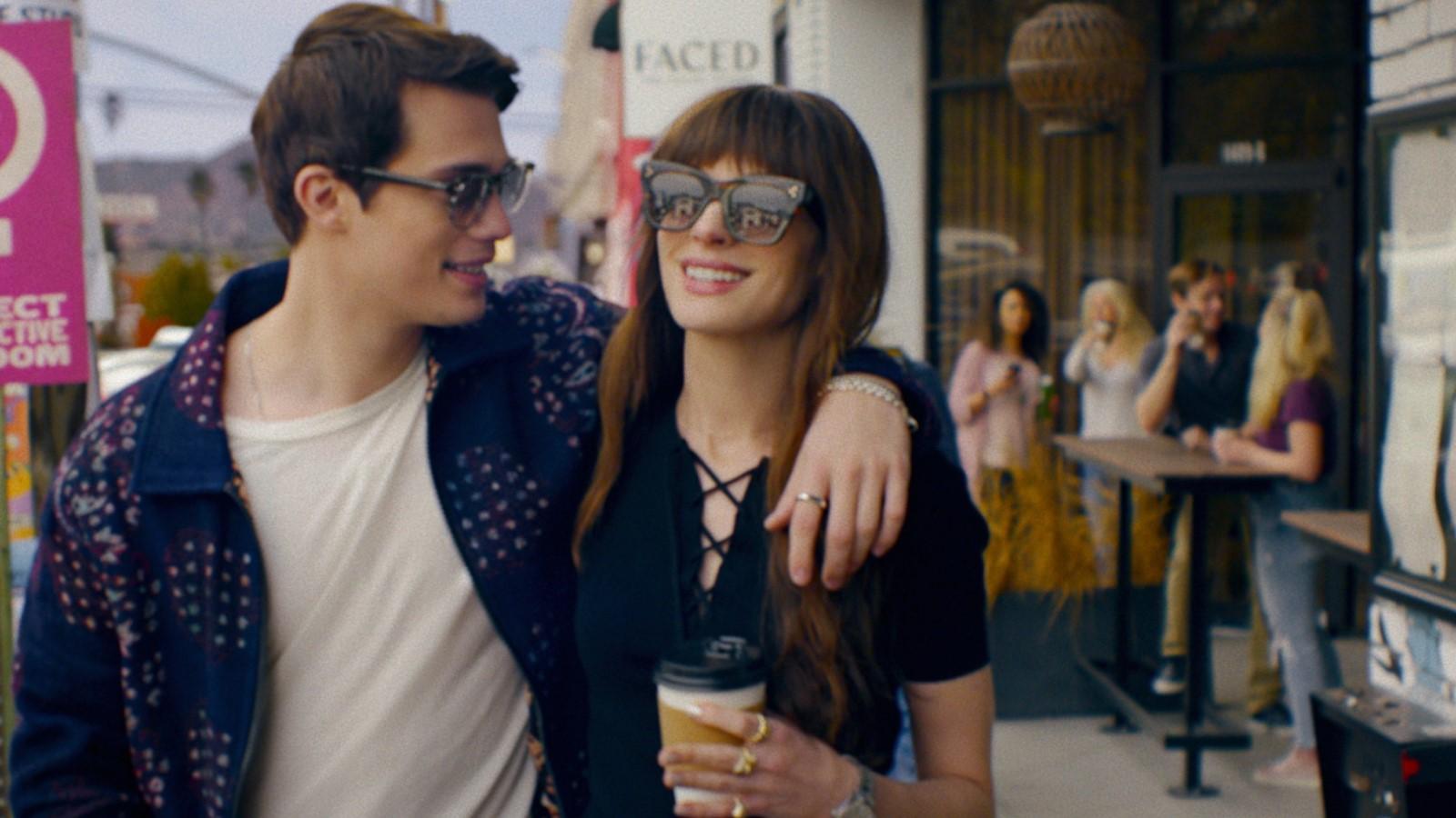 Anne Hathaway and Nicholas Galitzine as Sophie and Hayes in The Idea of You, walking down the street