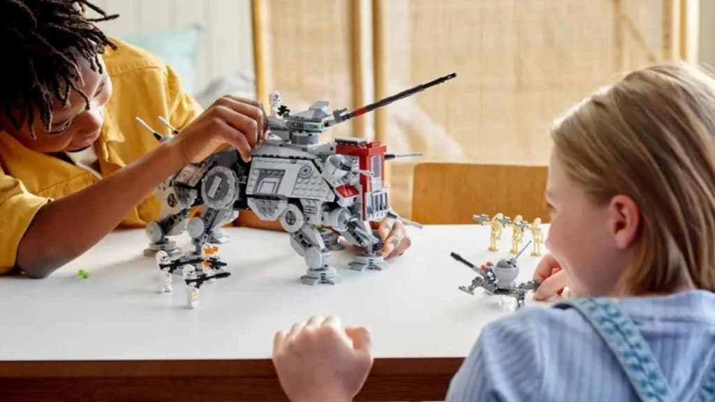 Two kids playing with the LEGO Star Wars AT-TE Walker, which has been discounted at Walmart
