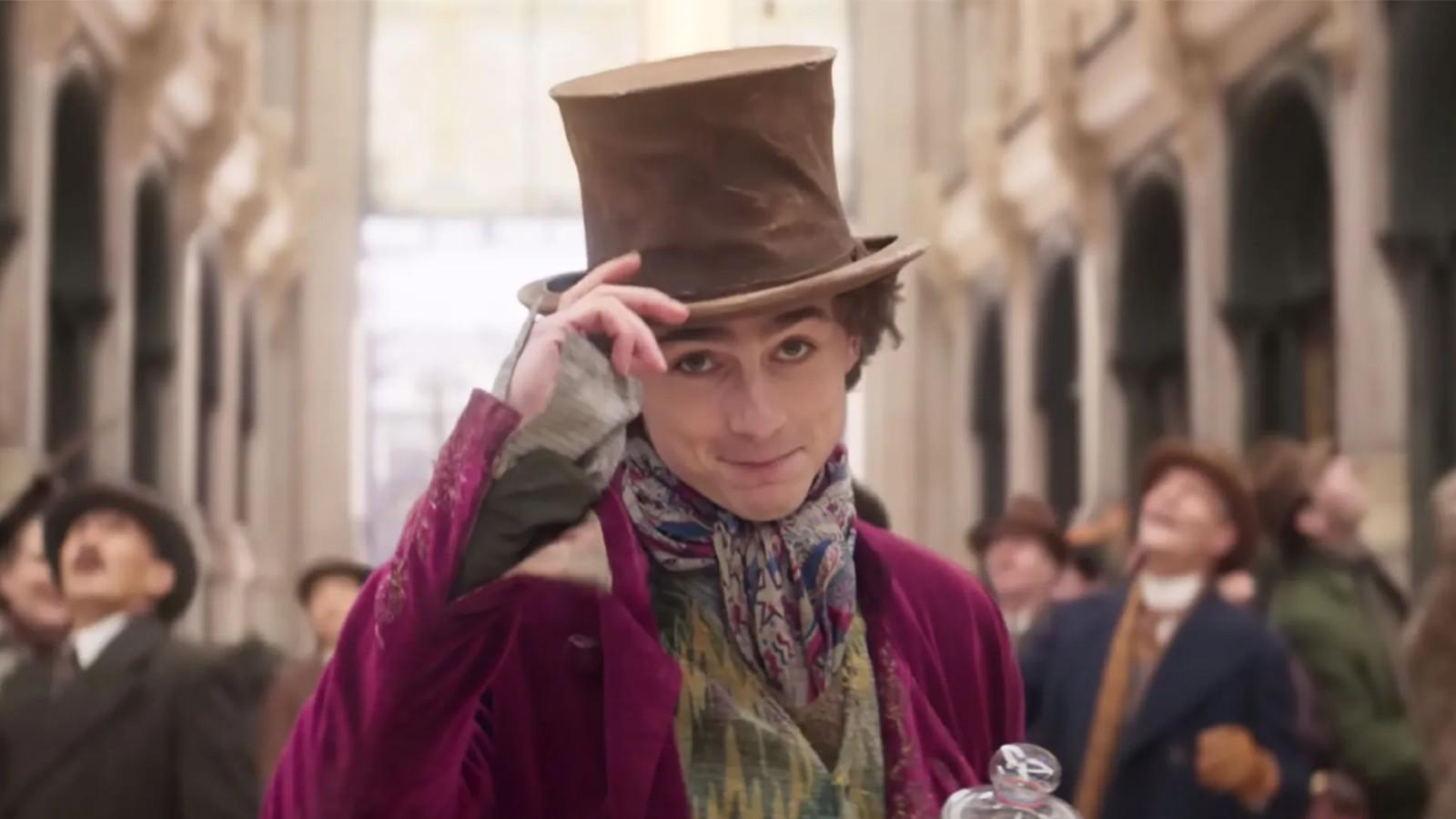 Timothée Chalamet tipping his hat as Willy Wonka.