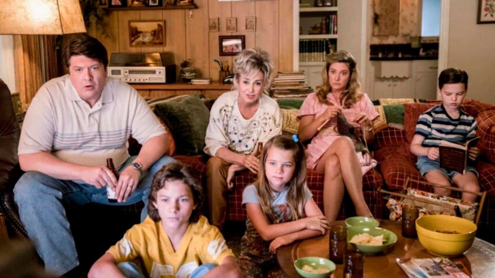 The Cooper family sit down to watch TV in Young Sheldon