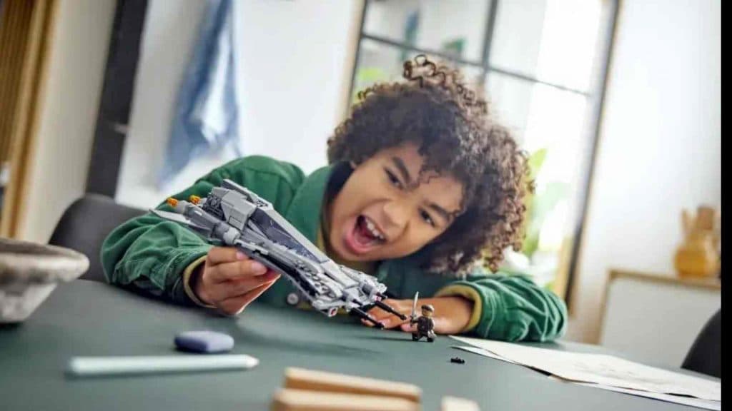 A child playing with their LEGO Star Wars Pirate Snub Fighter