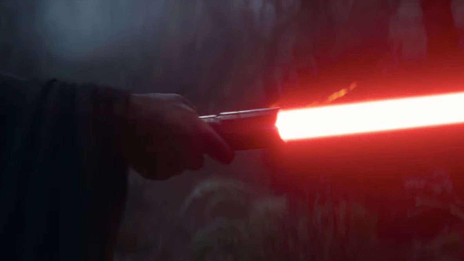 A hand holding a Sith red light saber