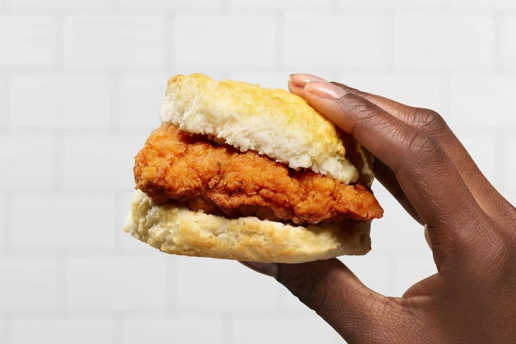 A biscuit with fried chicken