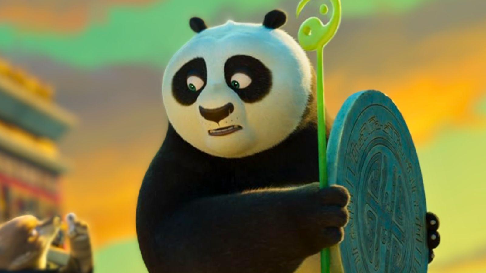 Jack Black as Po in Kung Fu Panda 4. He's standing in front of a colourful sky holding a circular artefact.