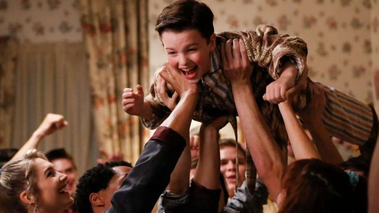 Sheldon being carried by a group of kids in Young Sheldon