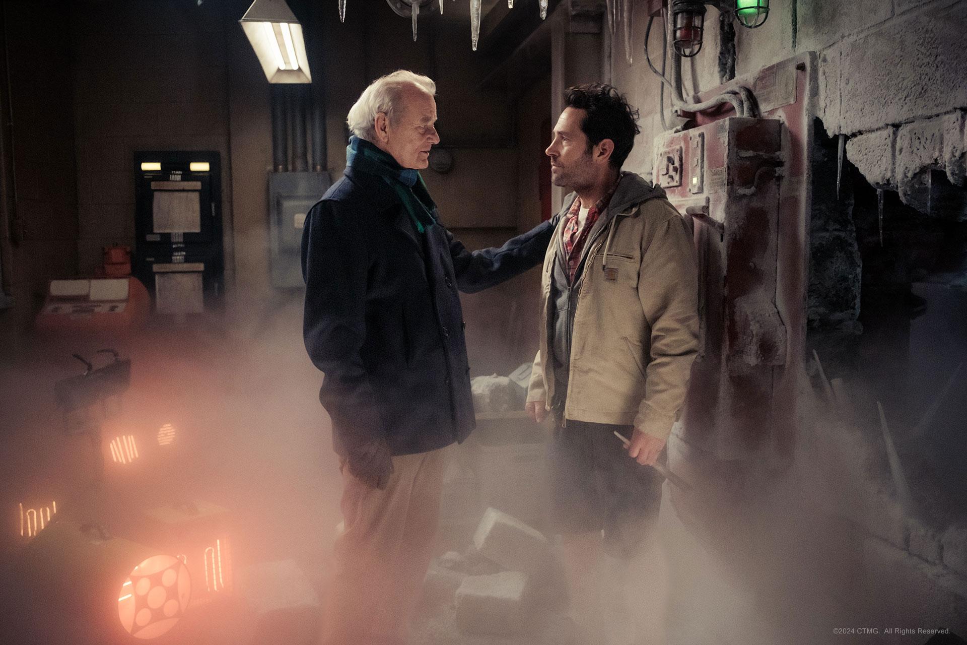 Paul Rudd and Bill Murray in Ghostbusters Frozen Empire. Murray speaks to Rudd in a misty room.