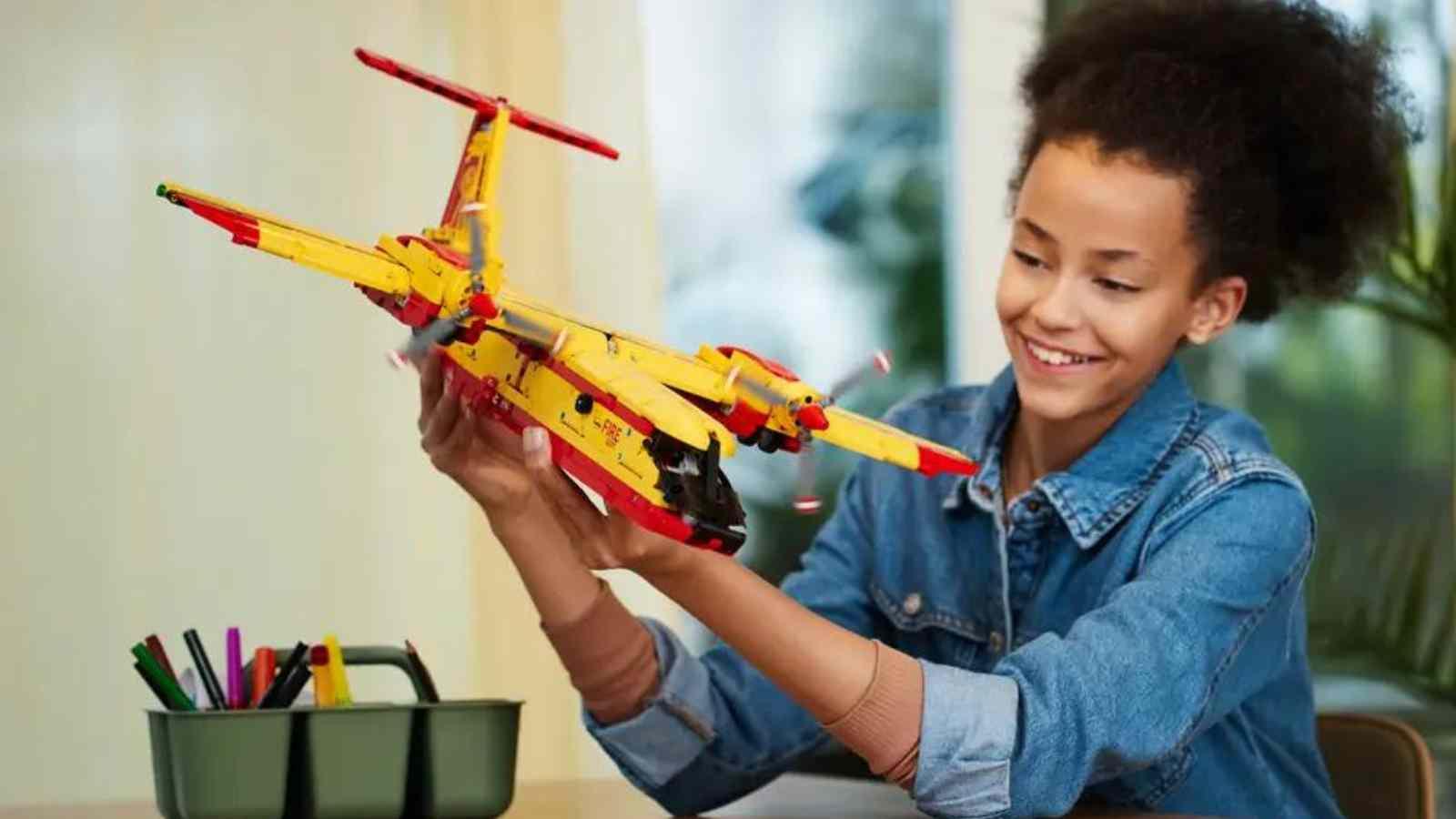 A child with their LEGO Technic Firefighter Aircraft