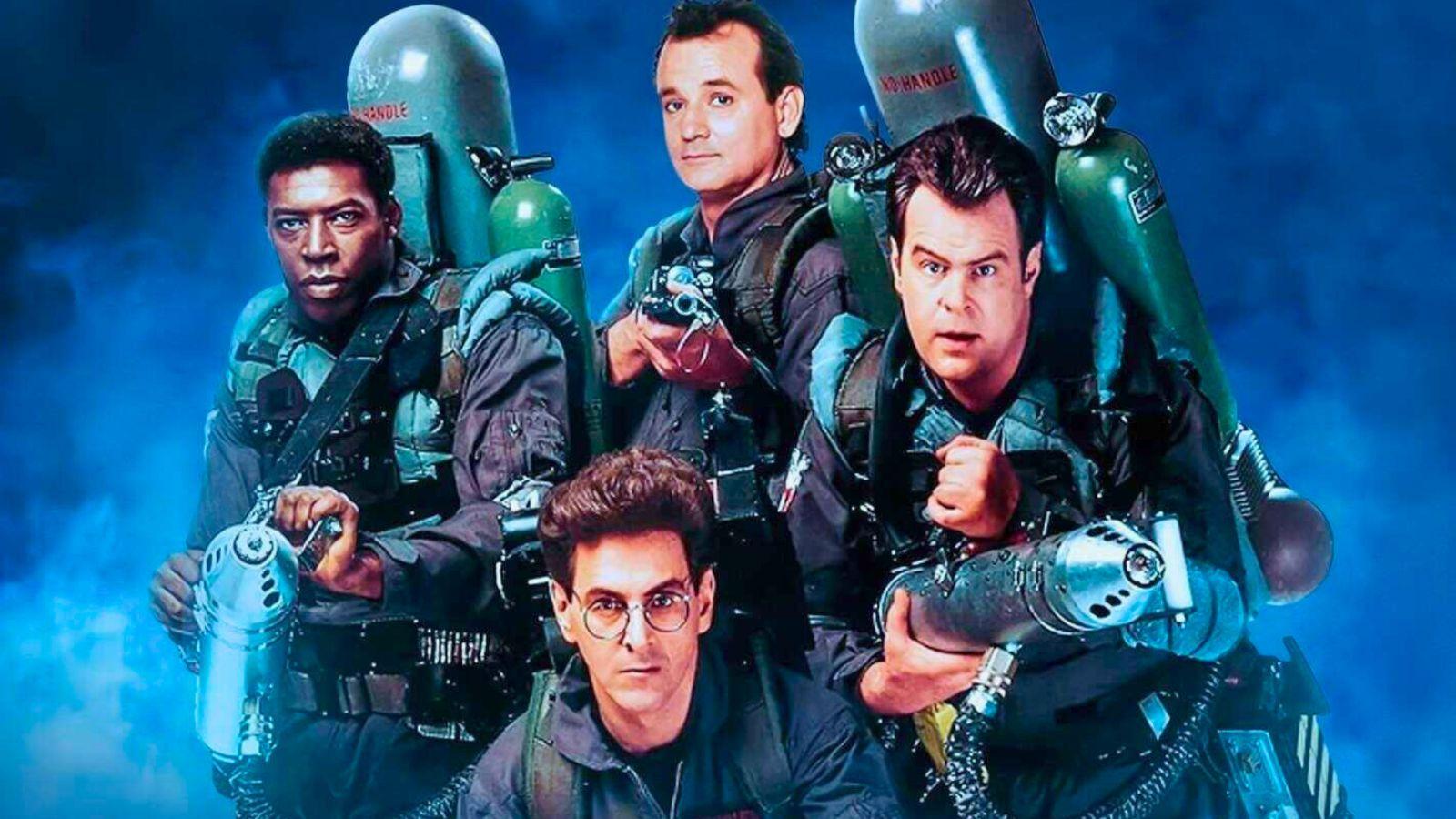 Ernie Hudson, Bill Murray, Dan Ackroyd, and Harold Ramis in a Ghostbusters 2 promotional image. They are in Ghostbusters uniforms and have their proton packs equipped.