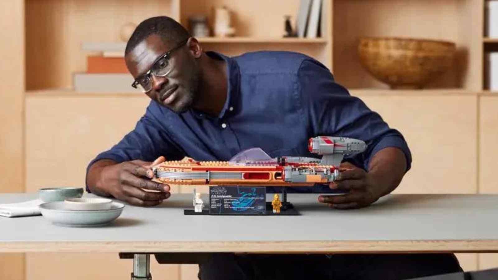 An adult with their LEGO Star Wars Landspeeder