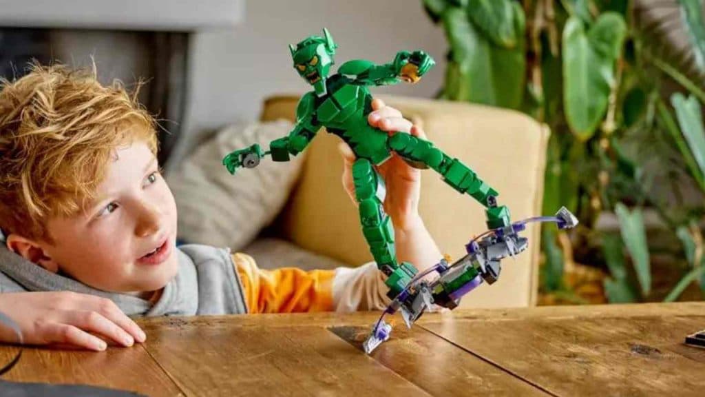 A child playing with their LEGO Marvel Green Goblin Construction Figure