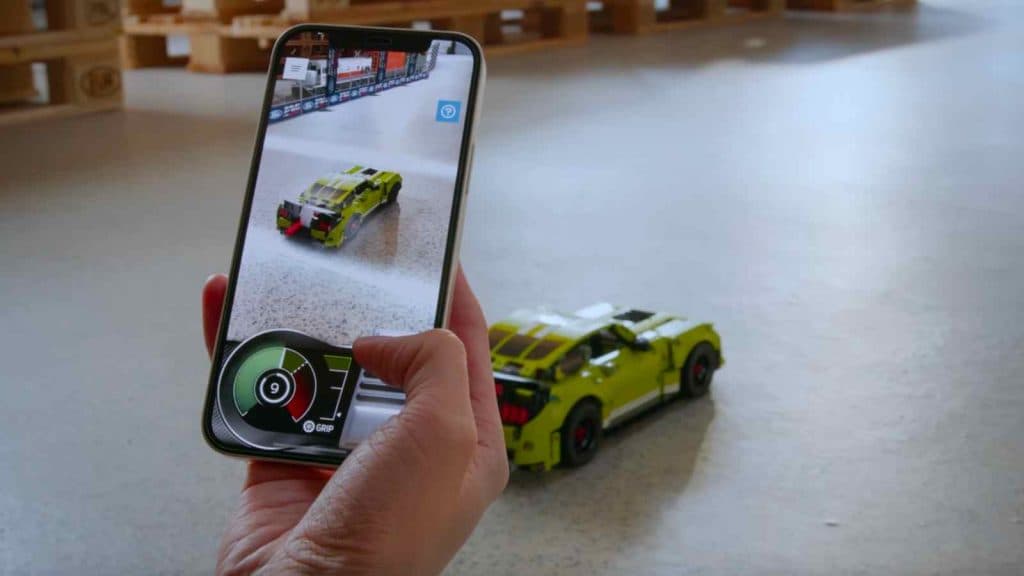 A LEGO builder using the LEGO AR app to race their LEGO Technic Ford Mustang Shelby
