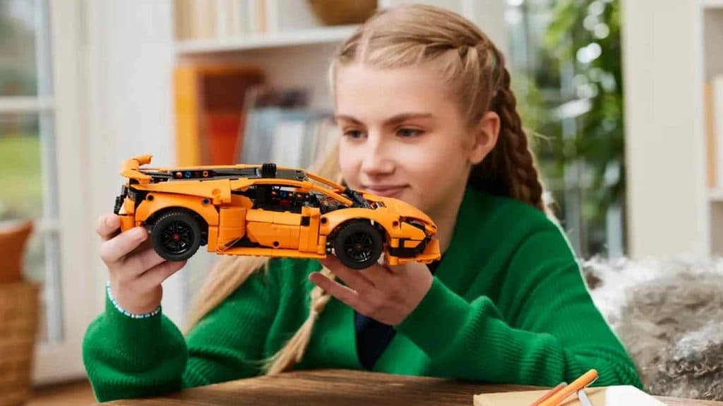 A child with their LEGO Technic Lamborghini Huracán Orange set