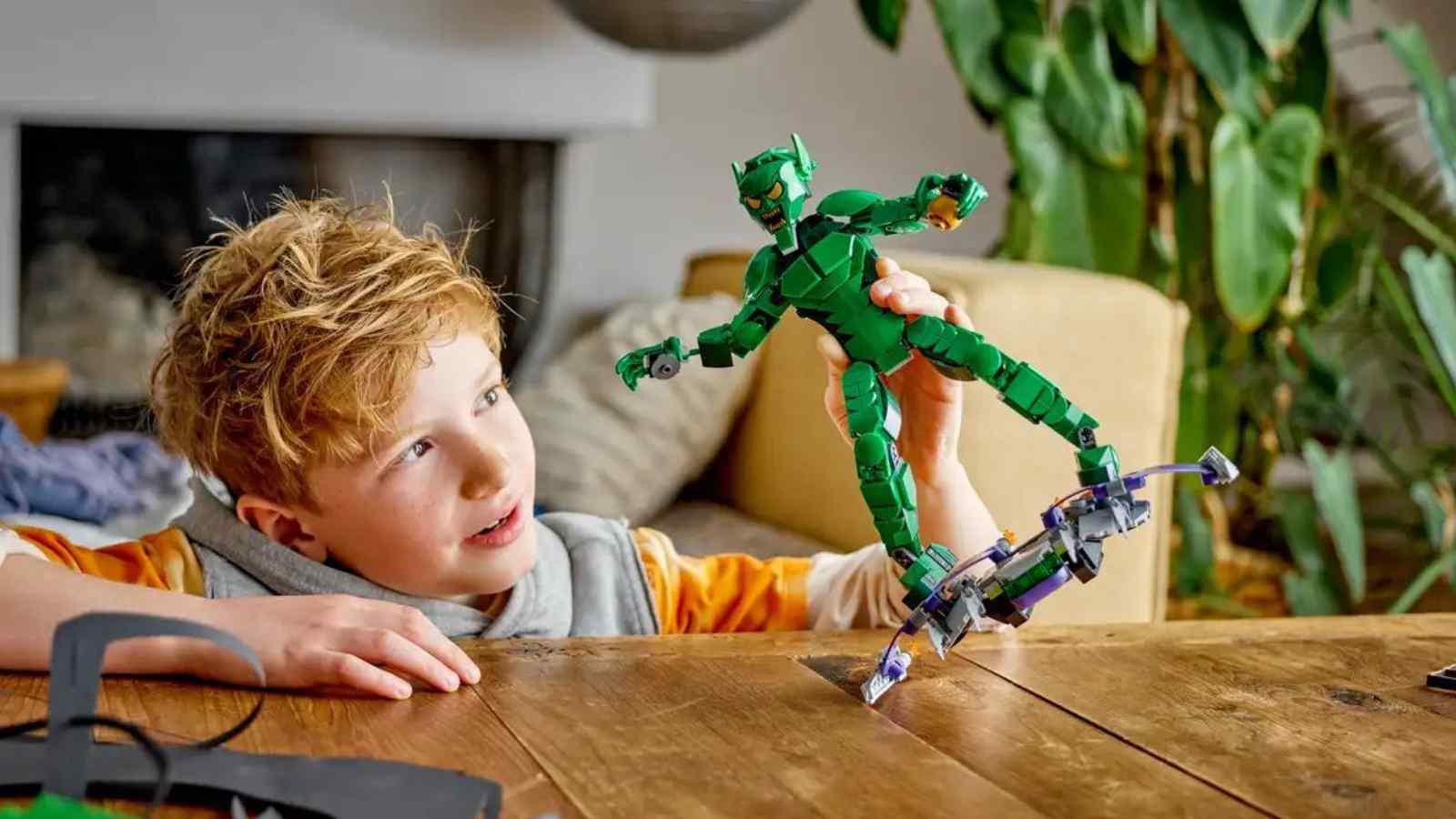A child playing with their LEGO Marvel Green Goblin