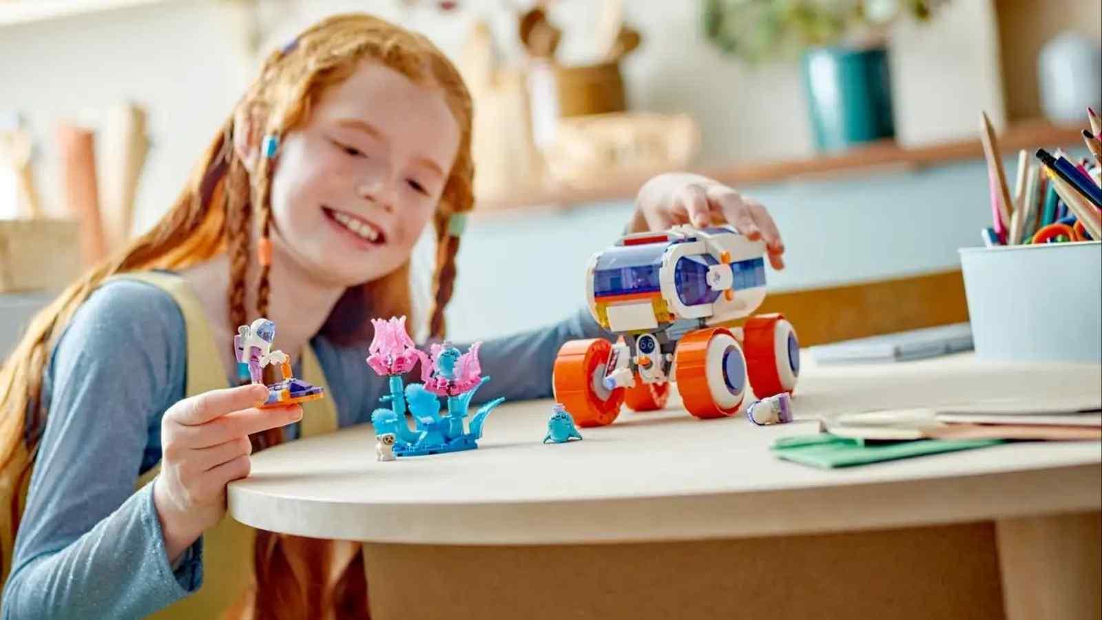 A child playing with their LEGO Friends Space Research Rover