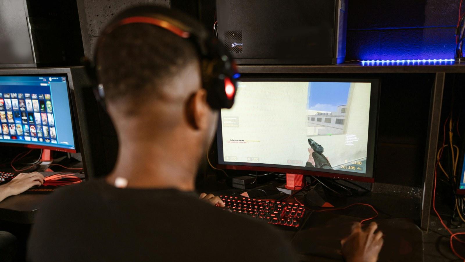 Man playing Counter Strike 2 at a gaming setup