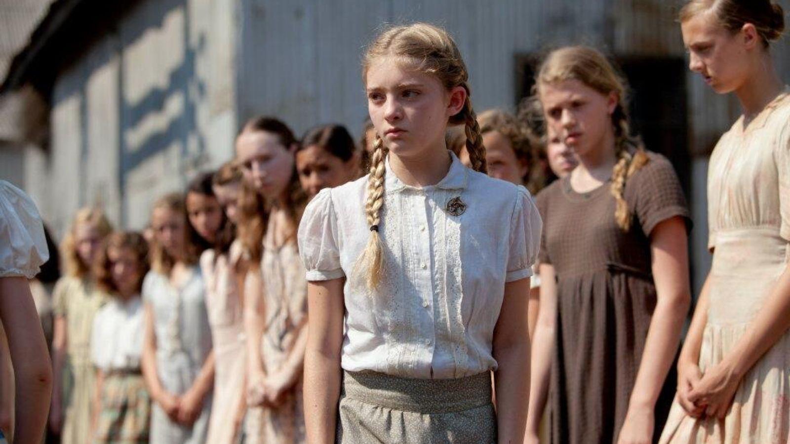 Willow Shields as Primrose Everdeen in The Hunger Games. She walks through the crowd of children during the reaping.