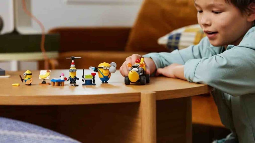A child playing with their LEGO Despicable Me 4 Minions and Banana Car