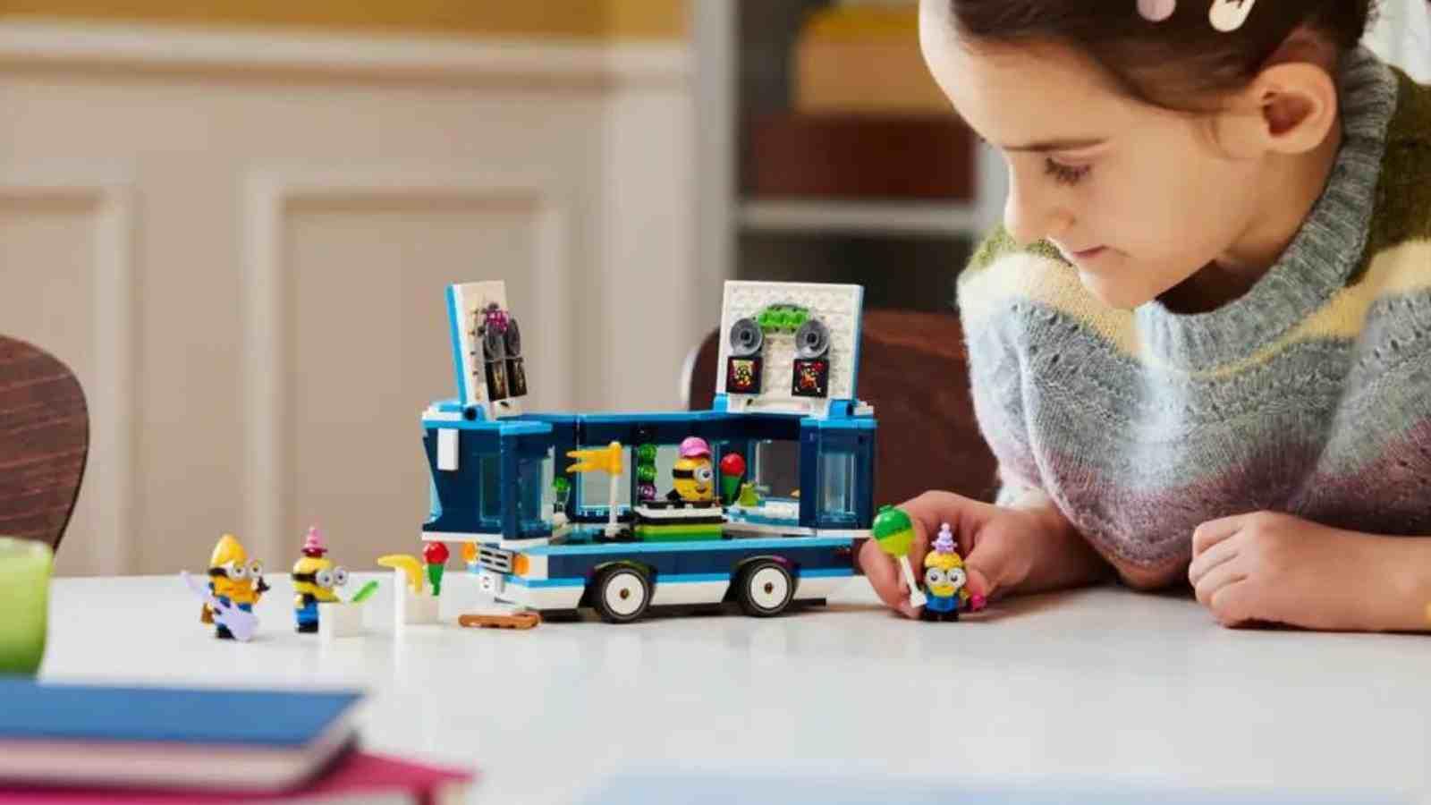 A child playing with their LEGO Despicable Me 4 Minions' Music Party Bus