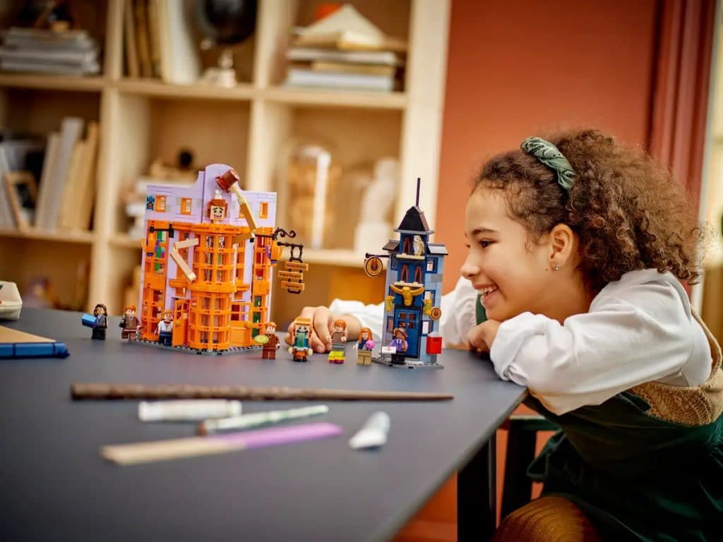 A child with their LEGO Harry Potter Diagon Alley: Weasleys' Wizard Wheezes set