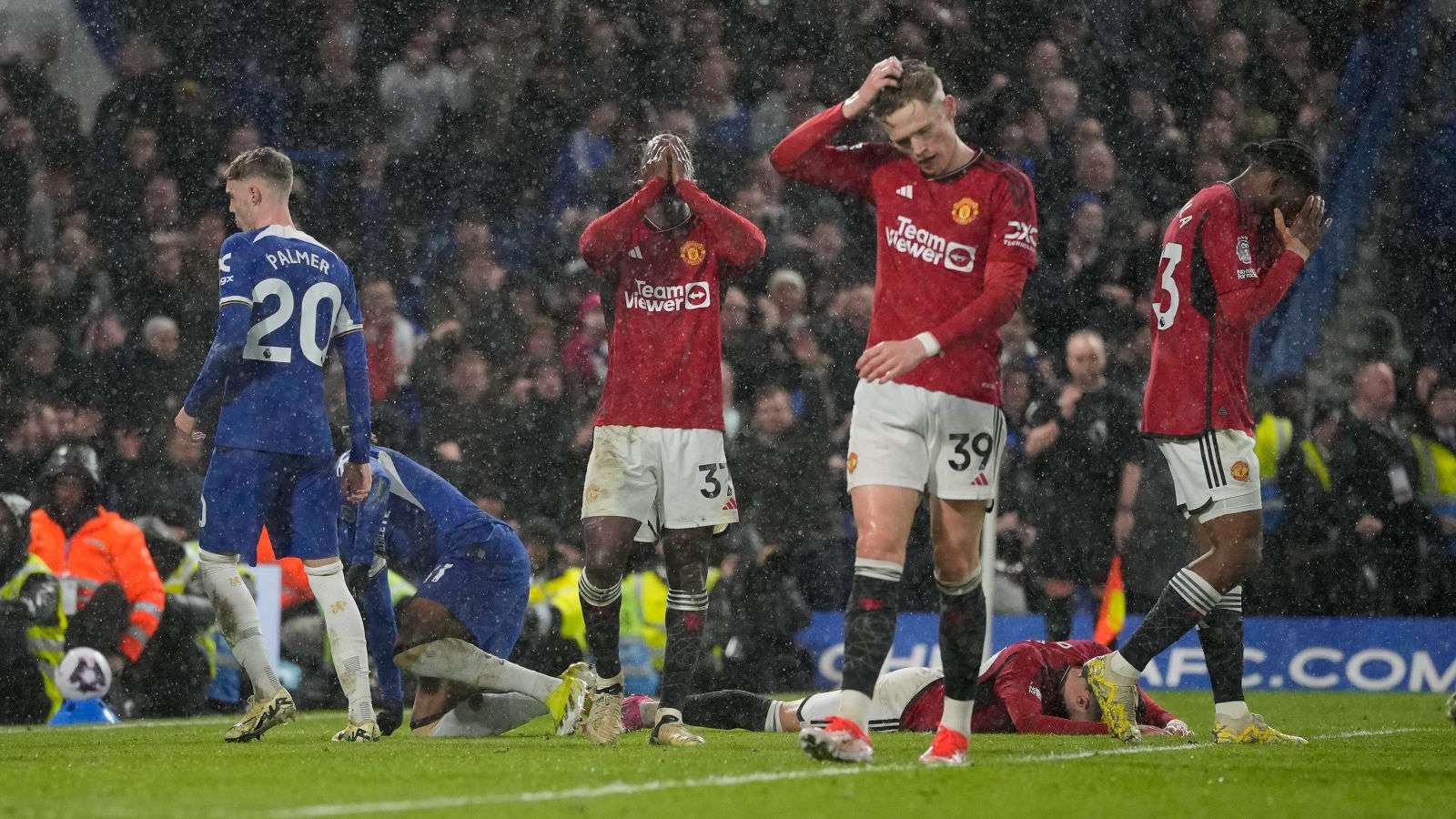 Manchester United players look dejected after Cole Palmer scores for Chelsea