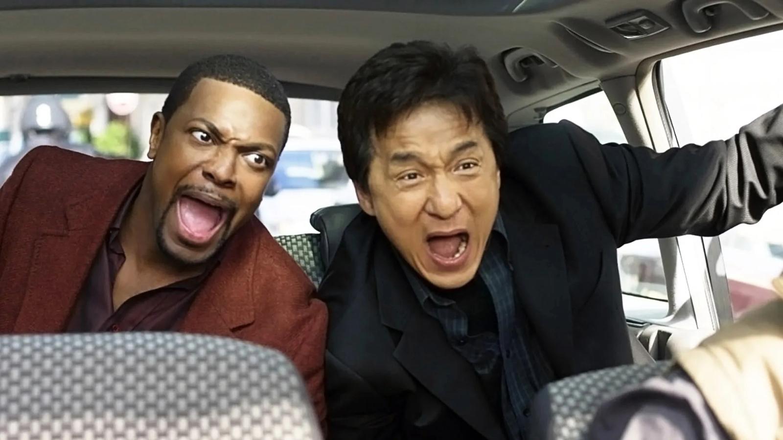 Chris Tucker and Jackie Chan as Carter and Lee in Rush Hour 2, sitting in a car and yelling