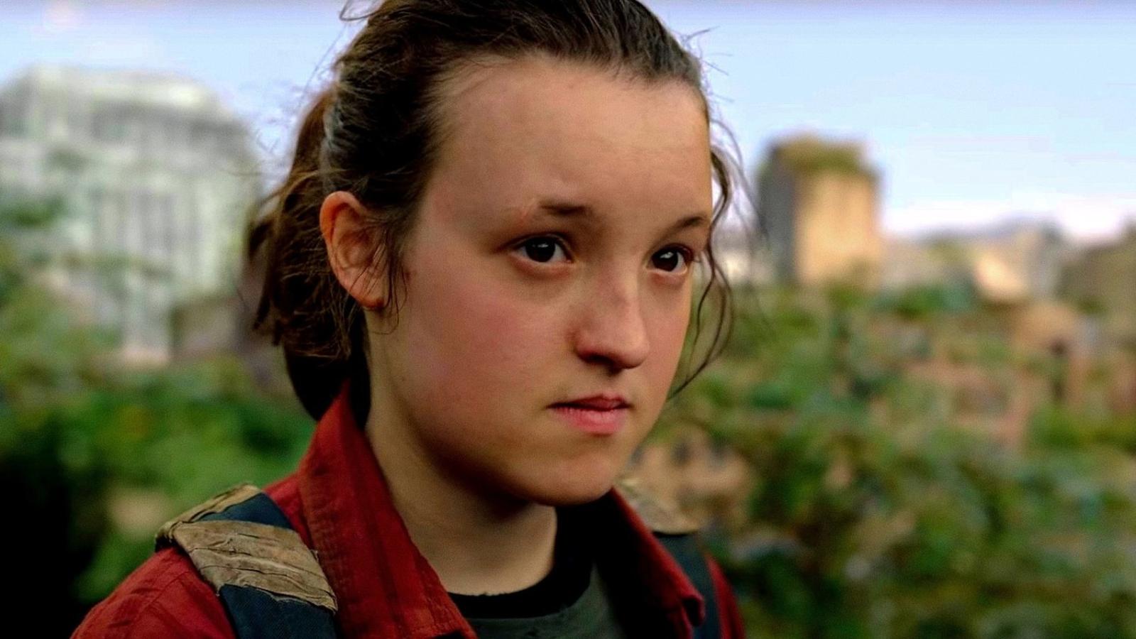 Bella Ramsey as Ellie in The Last of Us, standing in front of a ruined cityscape