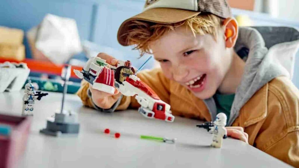 A child playing with their LEGO-reimagined BARC Speeder Escape set