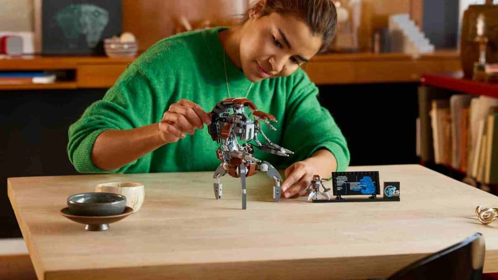 An adult with their LEGO Star Wars Droideka