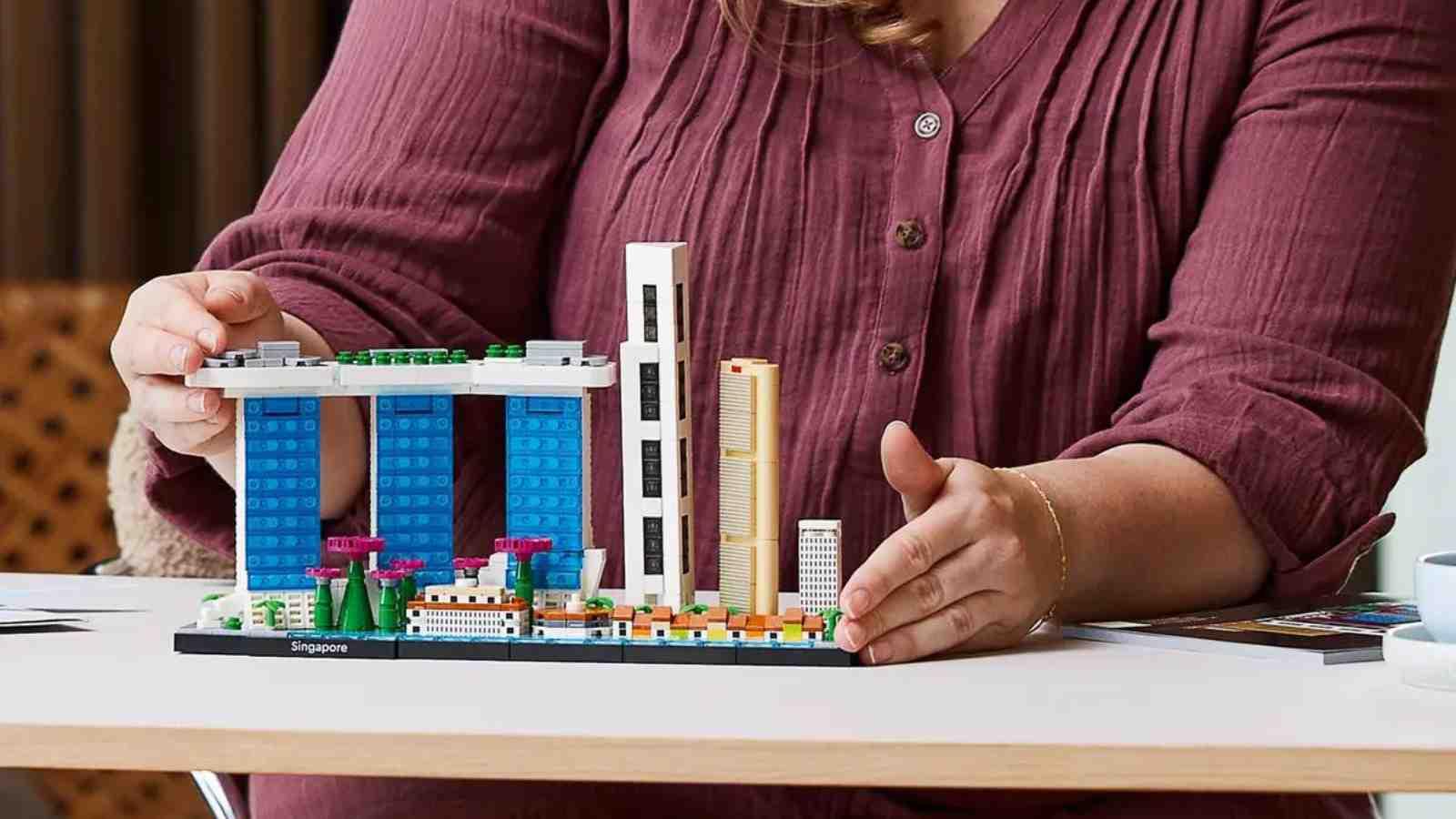 An adult with their LEGO Architecture Singapore set